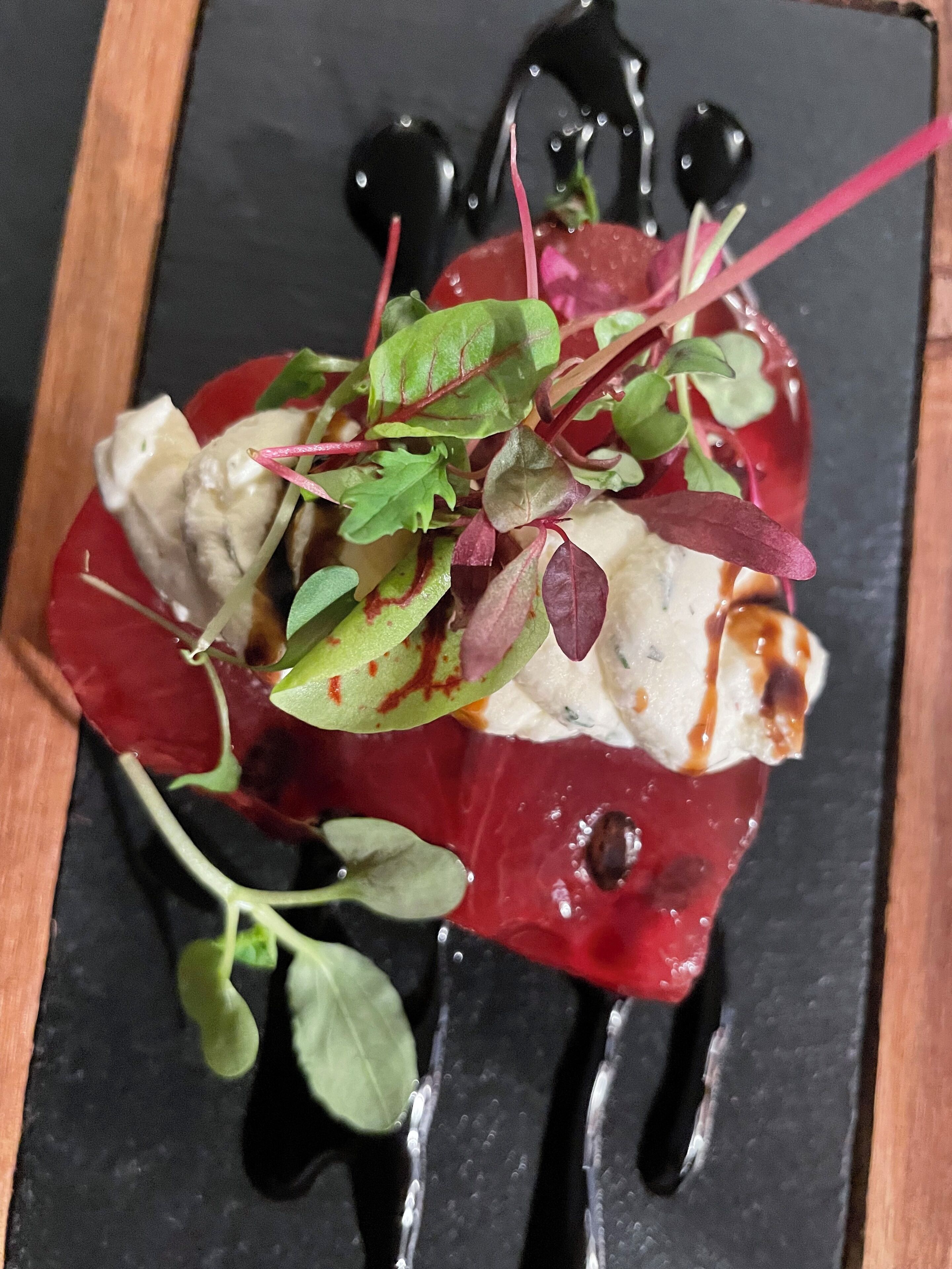 A dessert with various toppings and a dark background.