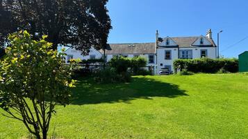 Traditional two-story house with a symmetrical facade and well-manicured lawn.