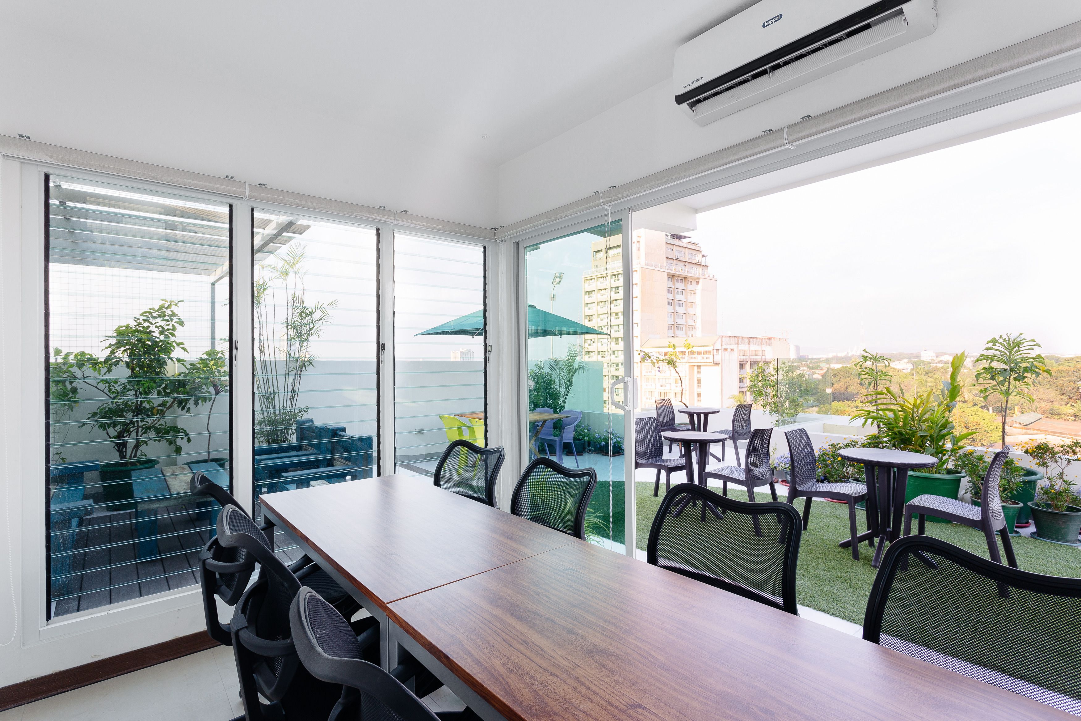 A modern room with a large sliding glass door leading to an outdoor patio area.