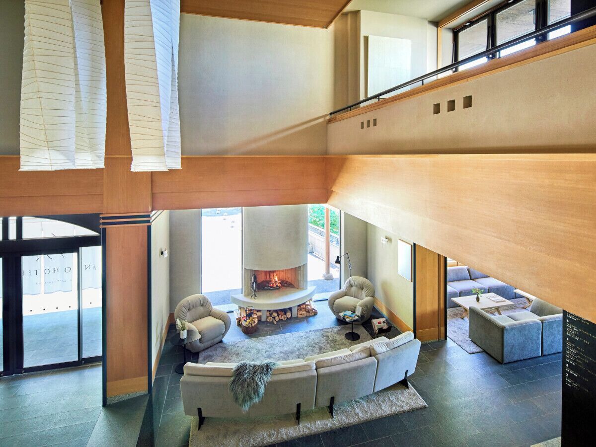 A spacious living area with a fireplace, seating, and a view of the outdoors.