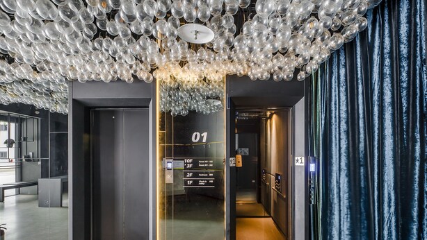 A modern elevator with a glass door, a digital display, and a sign indicating the floor number. - CHECK inn Taichung Liming (Taichung)