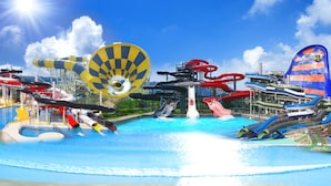 A water park with multiple slides and a large circular water feature. - Ooedo Onsen Monogatari Premium Seiunkaku (Awara)
