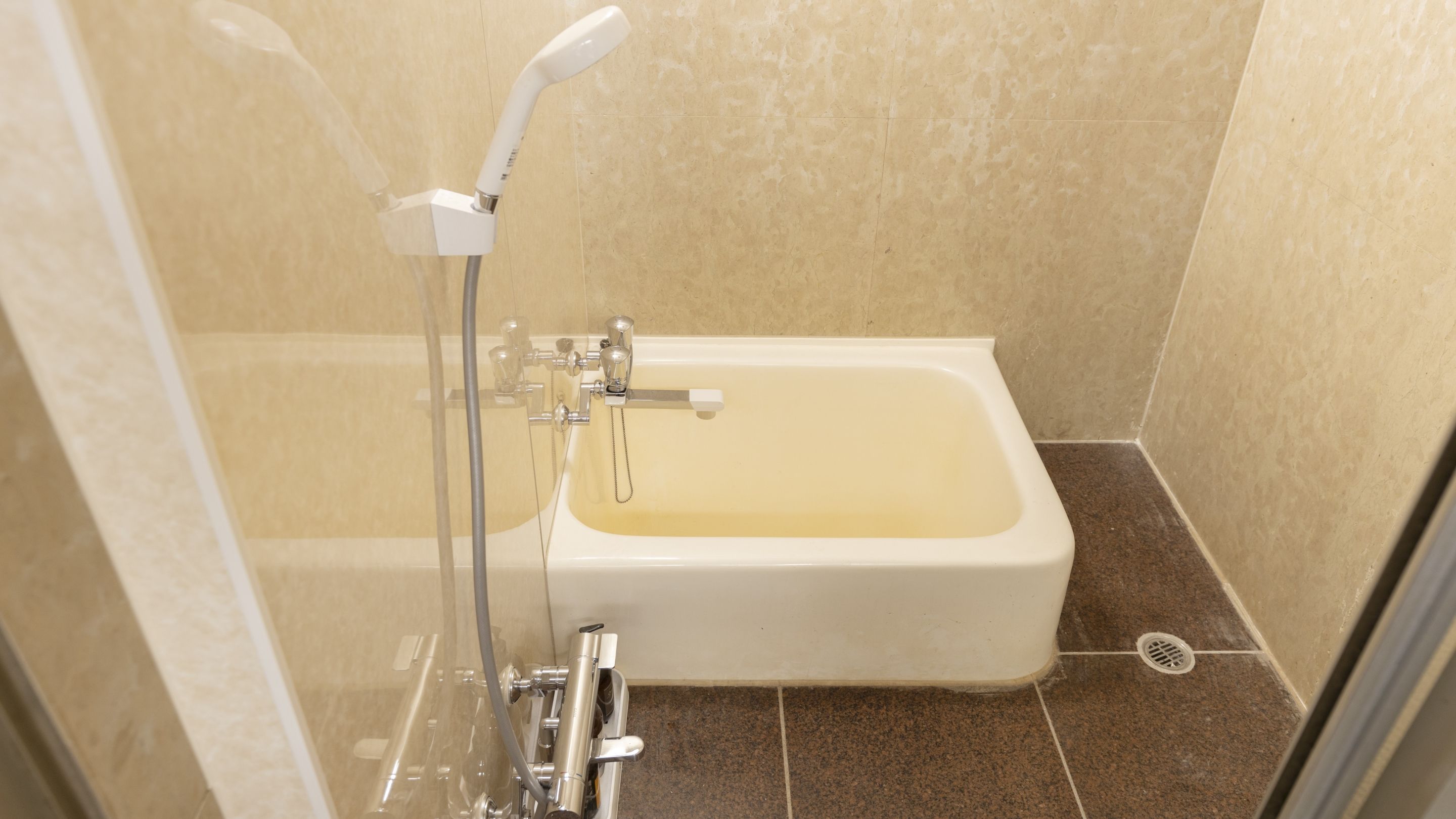 A bathroom with a bathtub, a shower, and a glass-enclosed shower area.