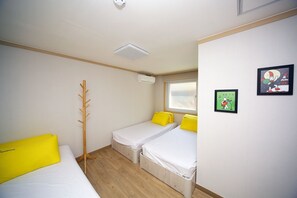 A room with two single beds, a coat rack, and a window. - 24 Guesthouse Seoul Cheongryangri (Seoul)