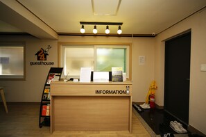 A reception desk with a 'guesthouse' sign, a bulletin board, and a fire extinguisher. - 24 Guesthouse Seoul Cheongryangri (Seoul)