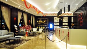 A modern hotel lobby with a reception desk, seating area, and decorative elements. - Geobay Hotel (Johor Bahru)