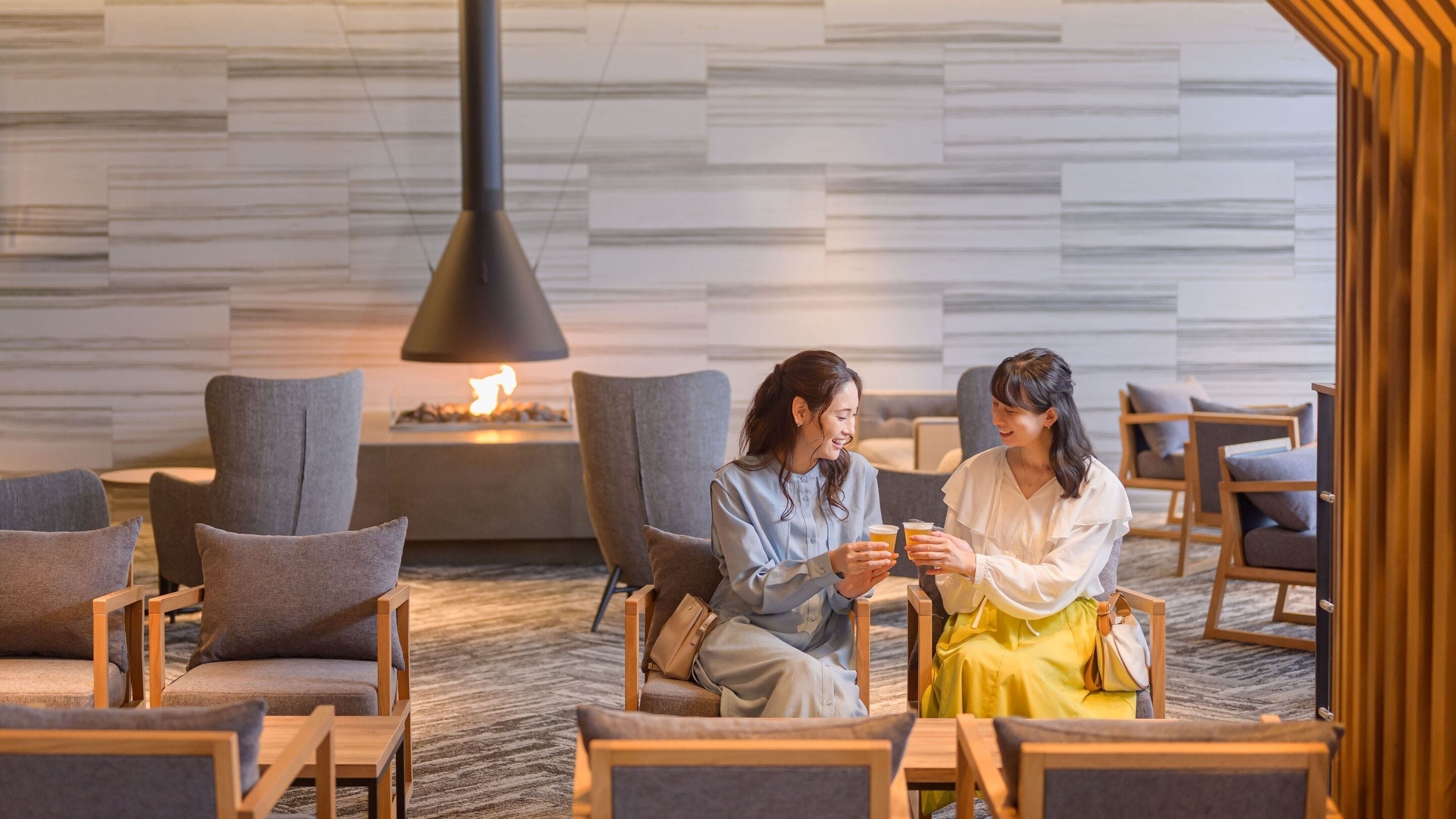 A modern lounge area with seating and a fireplace.