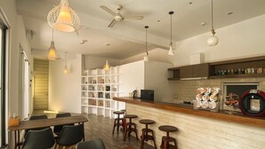 Una cocina moderna con encimera de madera, una estantería empotrada y un comedor con mesa y sillas de madera.