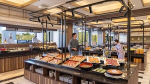 A buffet with various food items, a chef, and a server. - Ooedo Onsen Monogatari Premium Shima Saichoraku (Shima)