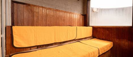 A room with a wooden bench and a window.