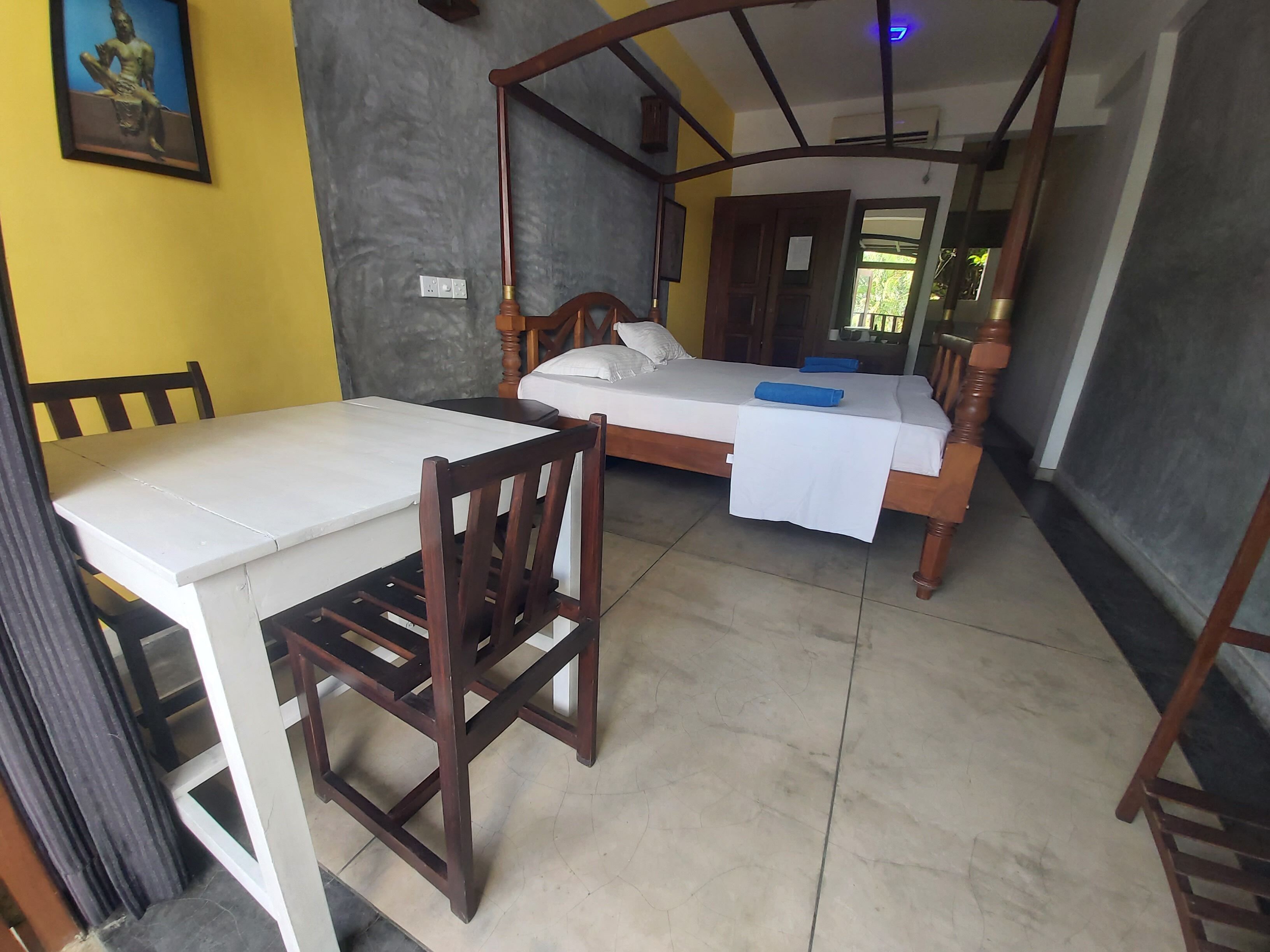A room with a bed, a table, and a chair.