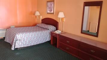 A hotel room with a bed, bedside lamps, a telephone, a dresser, and a mirror.