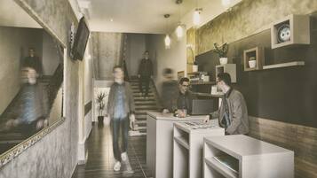 A reception area with a staircase, a reception desk, and a wall with shelves and decorative items.