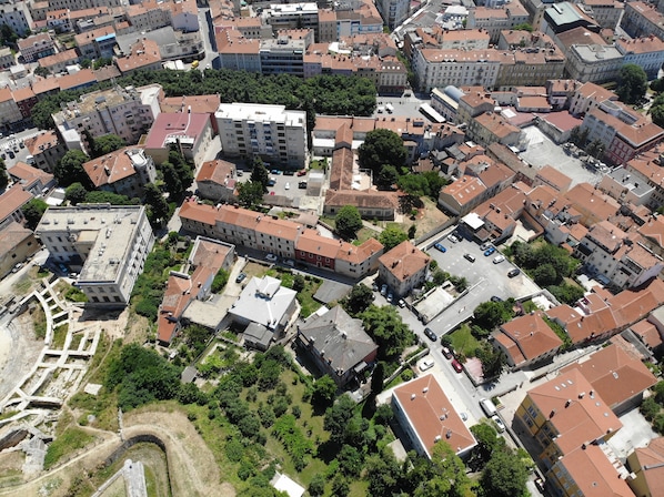 Vista aérea de una zona urbana densamente poblada con diversos edificios, incluyendo residenciales y comerciales de varios pisos.