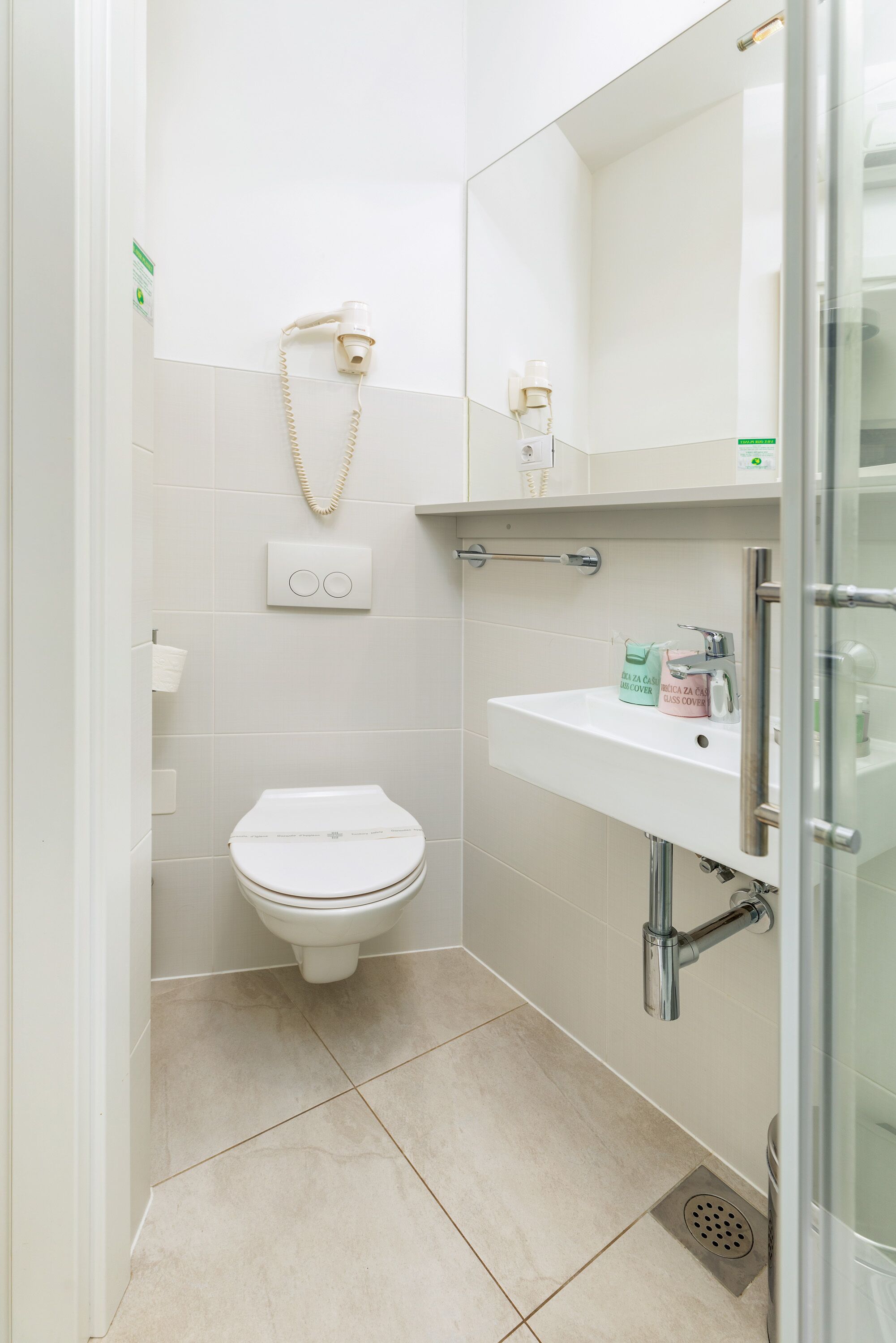 Un baño moderno con inodoro, lavamanos y ducha.