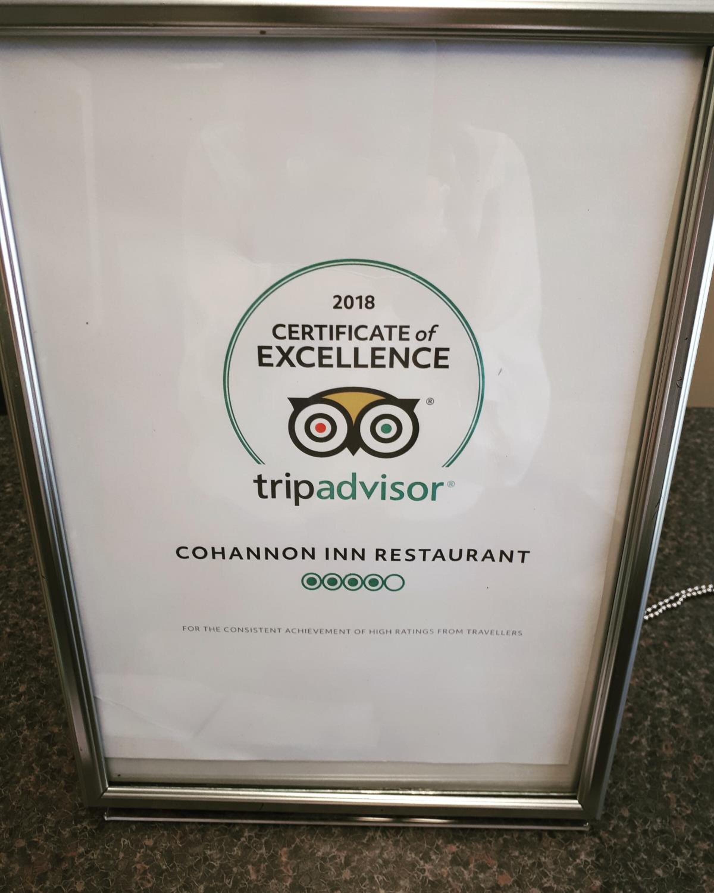 A framed certificate of excellence for the Cohannon Inn Restaurant, awarded by TripAdvisor in 2018.