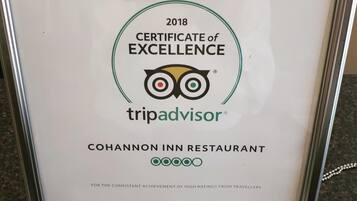 A framed certificate of excellence for the Cohannon Inn Restaurant, awarded by TripAdvisor in 2018.