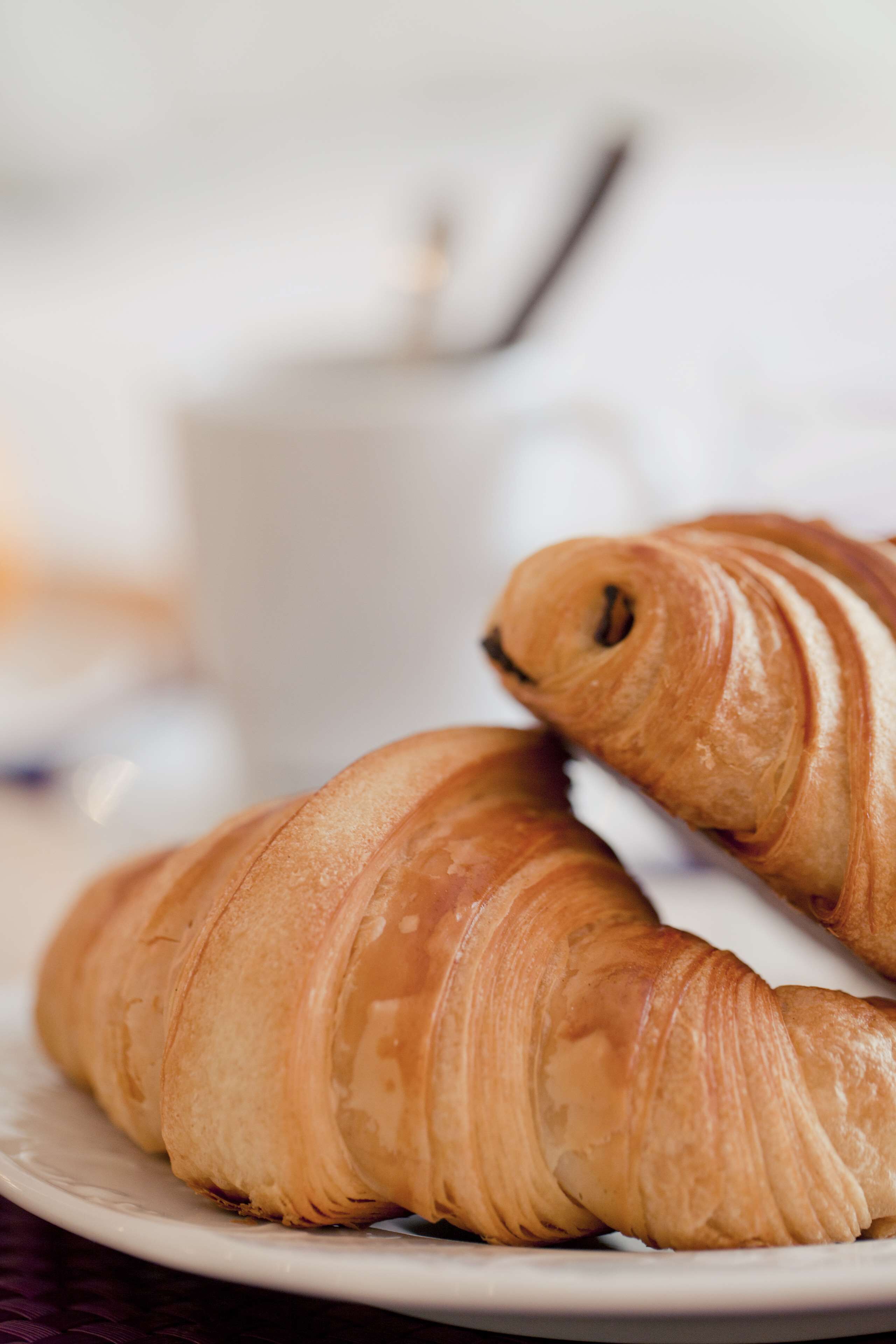A plate with two croissants.