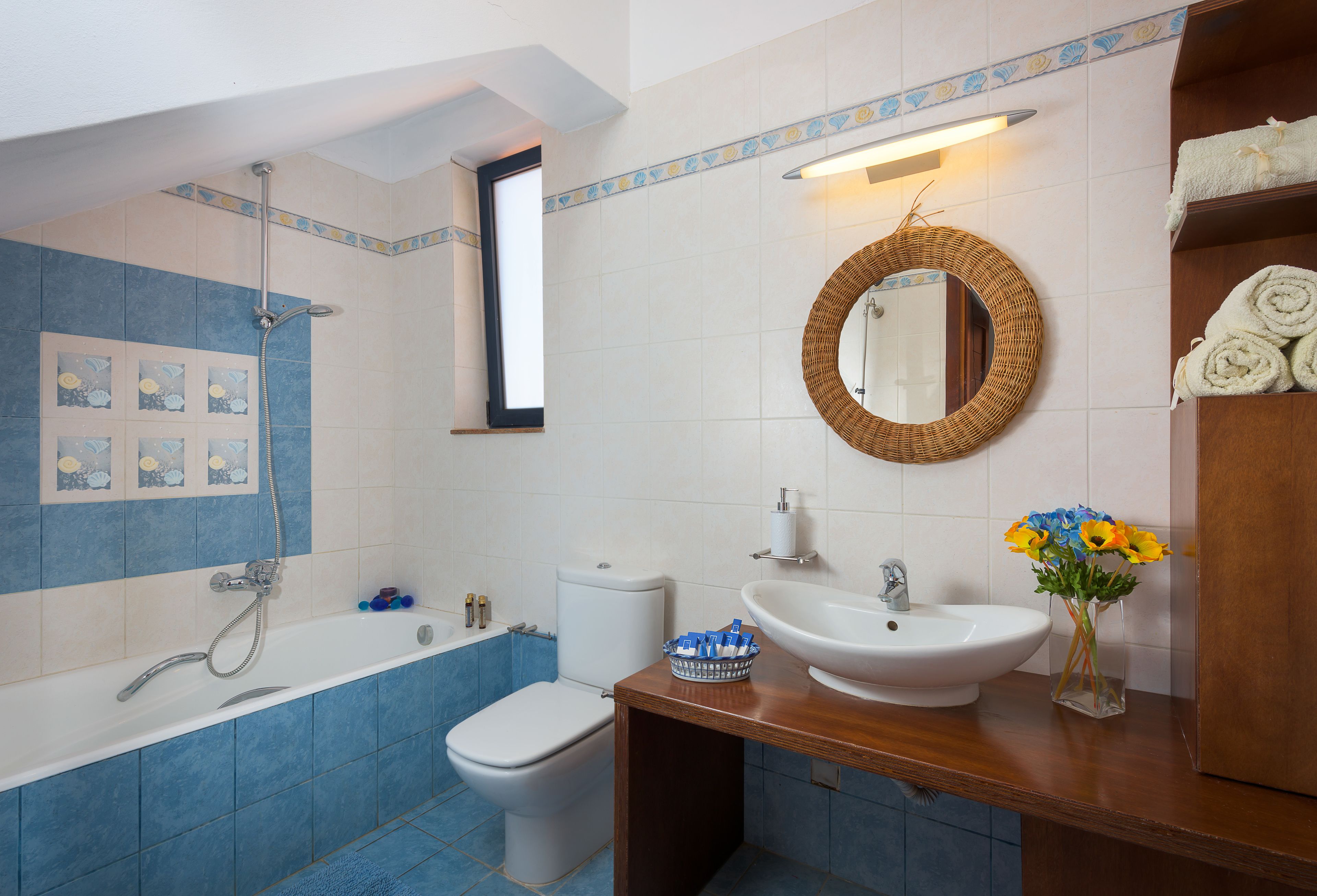 A bathroom with a bathtub, toilet, and sink.