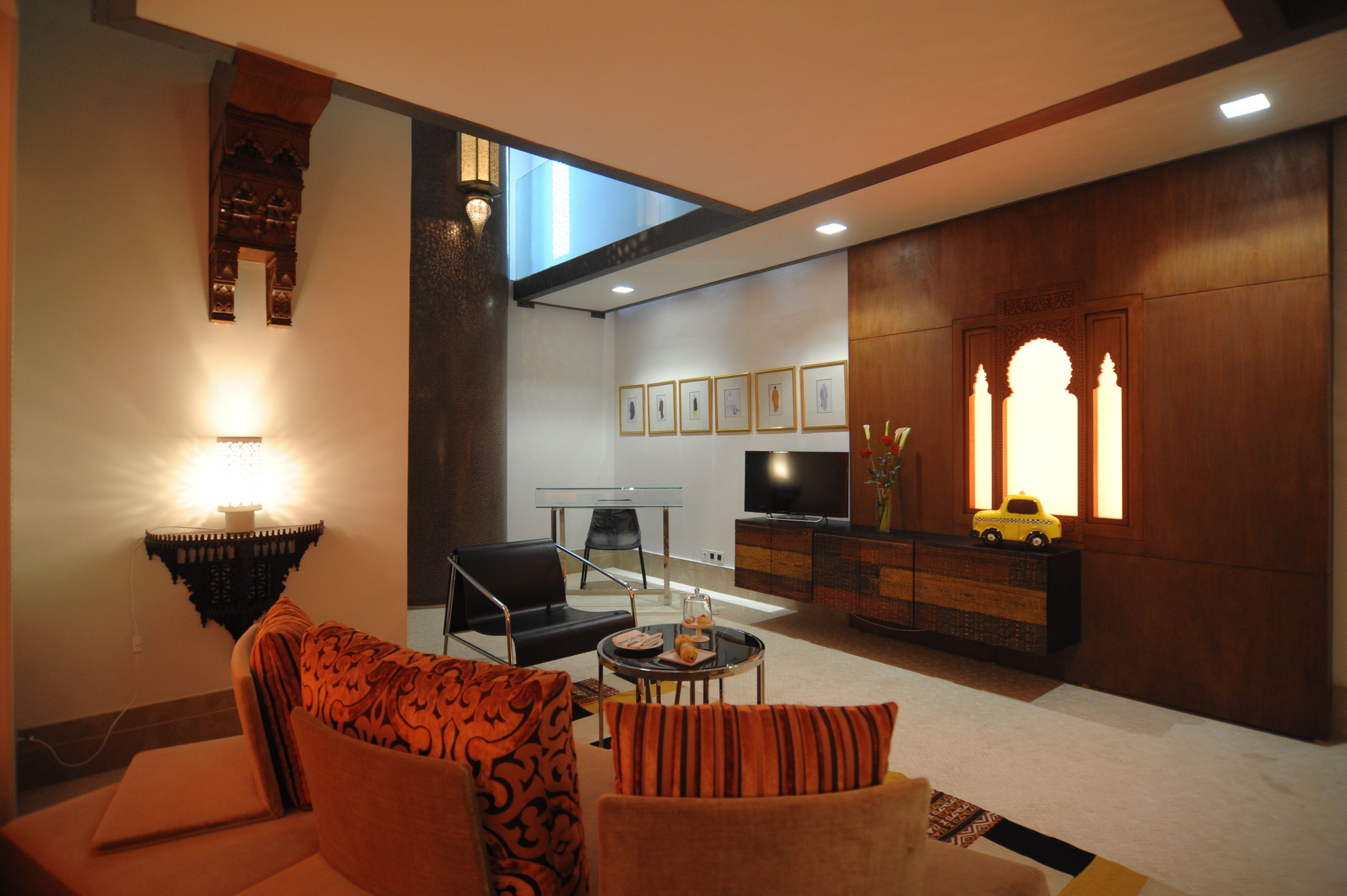 A modern living room with a sofa, a coffee table, a TV, and a wooden cabinet.