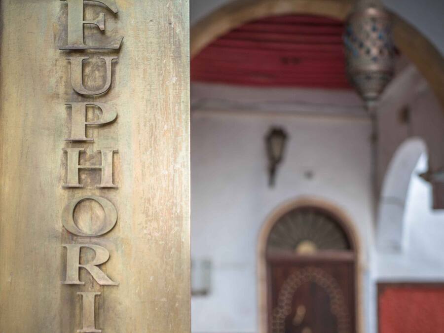 A brass plaque with the inscription "EUPHORIA" on a door.