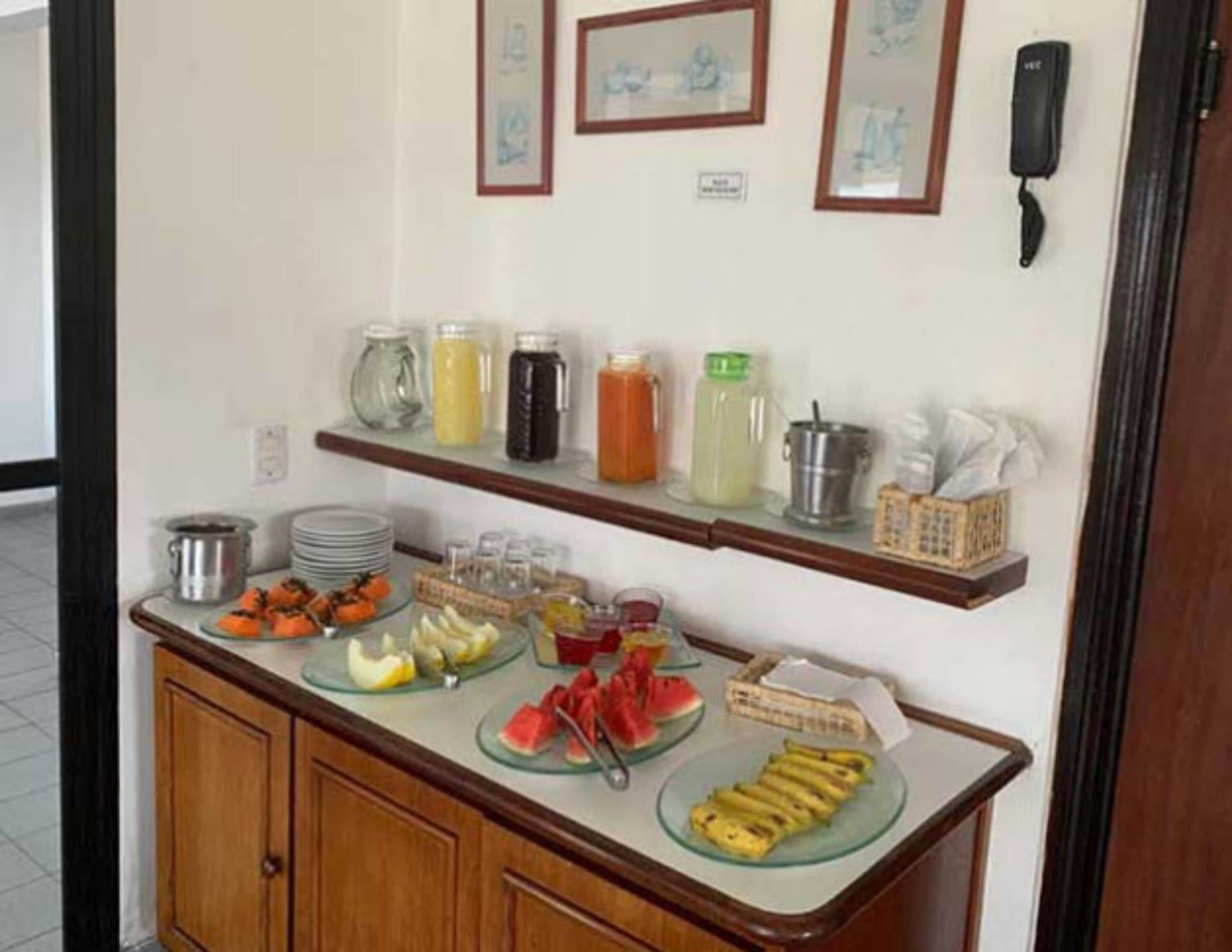 A buffet setup with various food items and beverages.