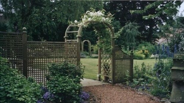 A garden pathway with a wooden arbor and a gravel border. - Spylaw Bank House (Edinburgh)