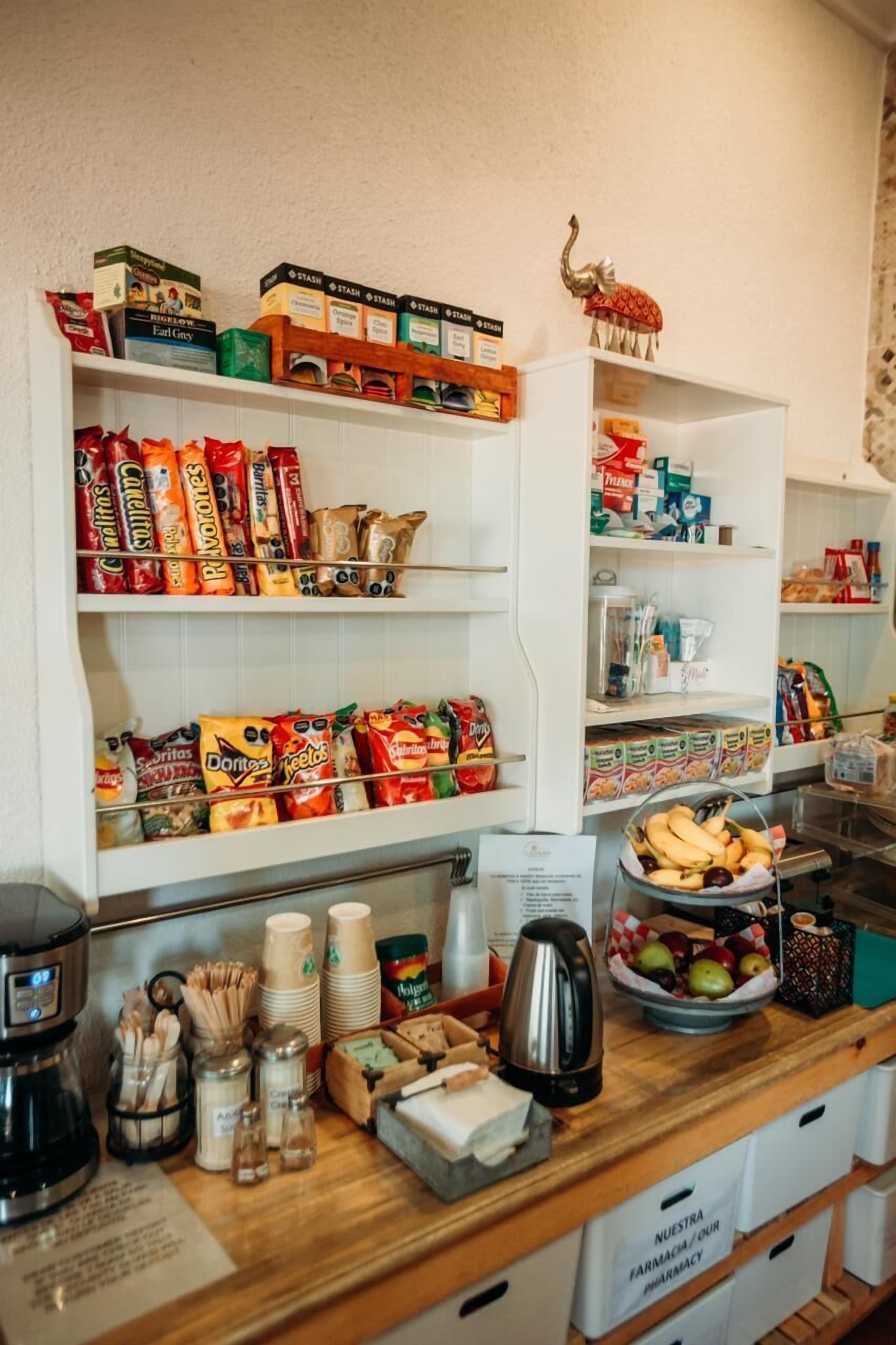 A snack bar with shelves stocked with various snacks and a coffee machine.