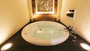 A modern bathroom with a freestanding bathtub, a decorative wall panel, and a built-in heater. - Hotel Atlantis Higashiosaka - Adults Only (Higashi-osaka)