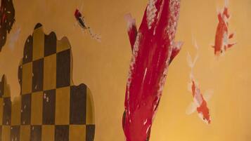 A close-up of a wall with a checkered pattern and a red paint smear.
