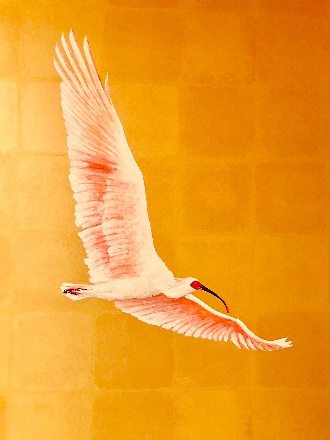 Un pájaro volando sobre un fondo amarillo.