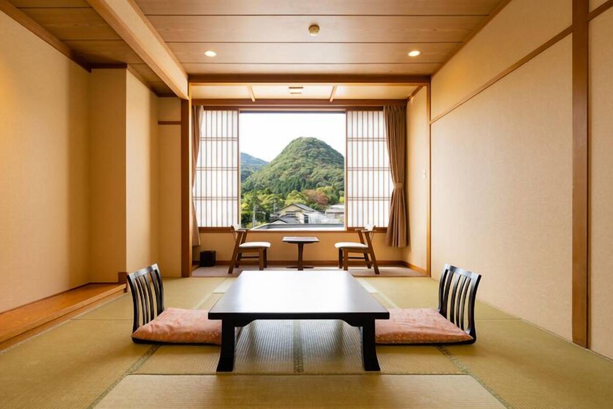 A traditional Japanese room with tatami flooring, a low table, and sliding shoji doors.