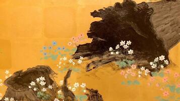 A painting of a tree trunk with flowers and a smaller tree.