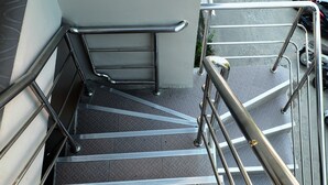 A set of metal stairs with handrails, leading to a landing area. - Chilli Hotel & Restaurant (Rayong)