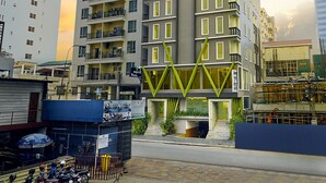A high-rise building with multiple balconies and a modern architectural design. - V Hotel Phnom Penh (Phnom Penh)