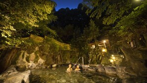 A hot spring area with rocky formations and a wooden fence. - Ooedo Onsen Monogatari Miyoshiya (Shinonsen)
