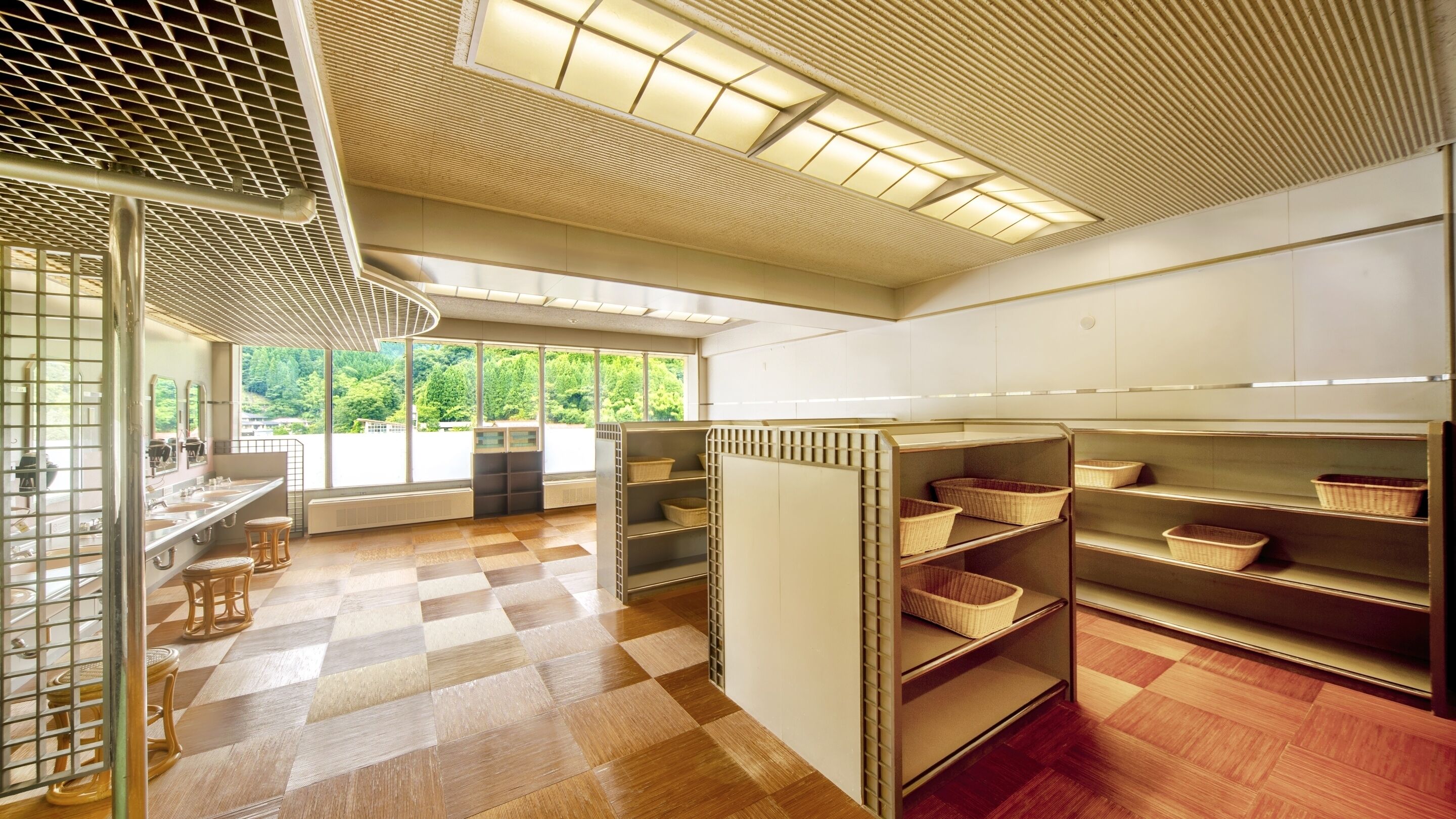 A modern kitchen with checkered flooring, large windows, and built-in shelves with baskets.