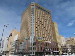 A tall hotel with multiple floors and a prominent sign for the Route Inn Grand. - Route-Inn Grand Asahikawa Ekimae (Asahikawa)