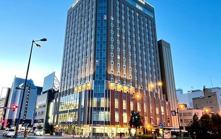 A high-rise hotel with multiple floors and a modern design, featuring large windows and a prominent signage at the top.
