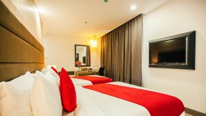 A hotel room with two beds, a desk, a chair, a television, and a mirror. - Verdant Hill Hotel Kuala Lumpur (Kuala Lumpur)