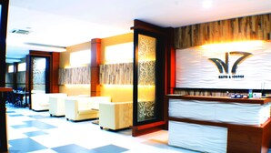 A reception area with a checkered floor, a reception desk, and seating areas. - Horison Kota Lama Semarang (Semarang)
