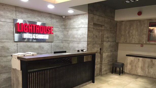 Una mesa de recepción con un letrero que dice "LIGHTHOUSE HOTEL & SHOREHOUSE".