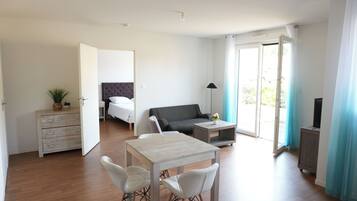 Apartment, 1 Bedroom | Living area | Flat-screen TV, heated floors