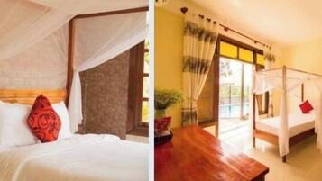 A room with a bed, a bedside table, and a window with curtains.