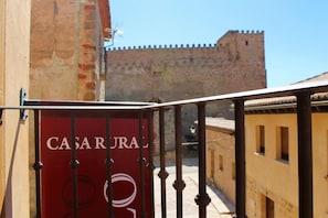 A red sign with "CASARAL" on a balcony railing. - Casa del Castillo (Siguenza)