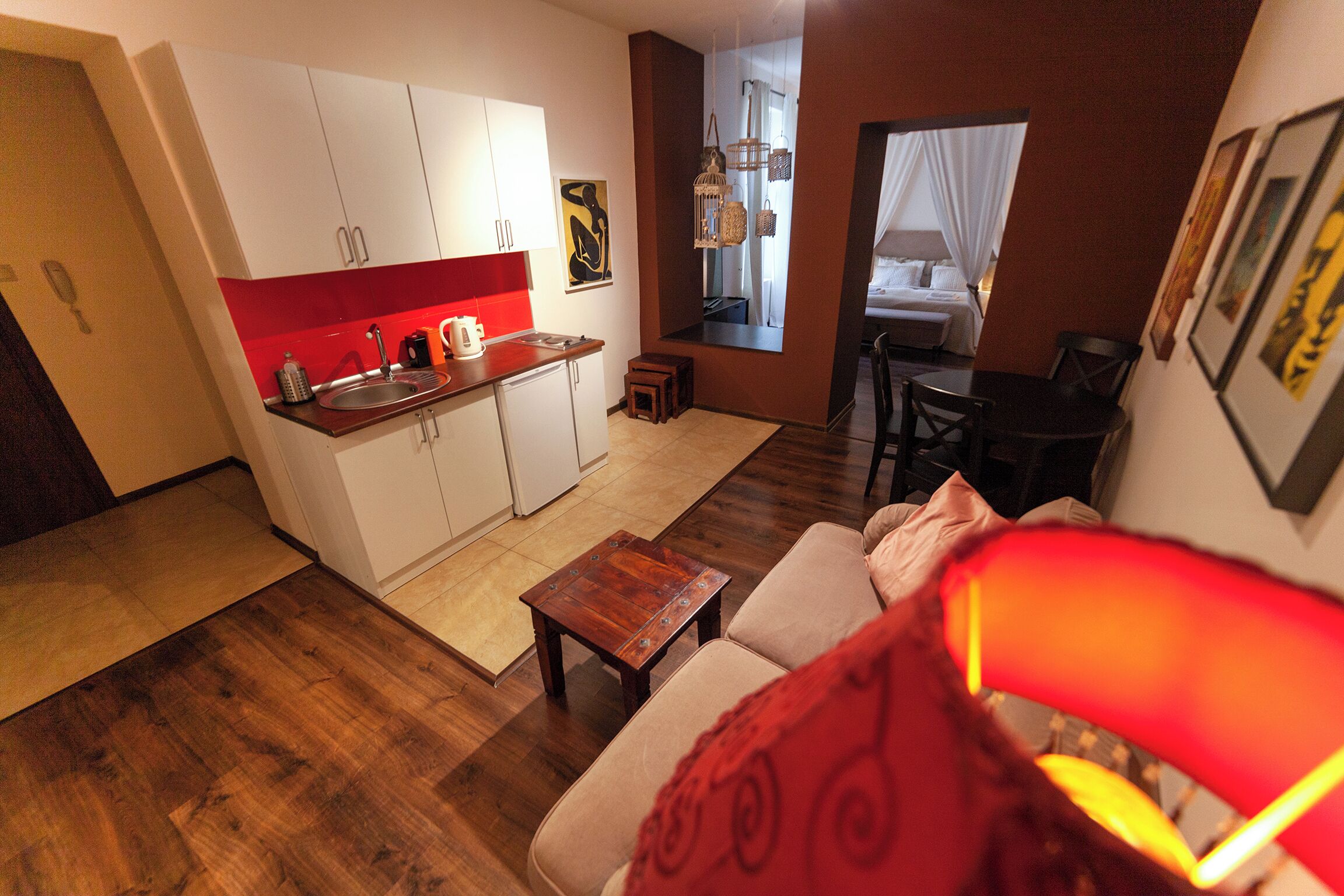 A compact living space with a kitchenette, a dining area, and a bedroom.