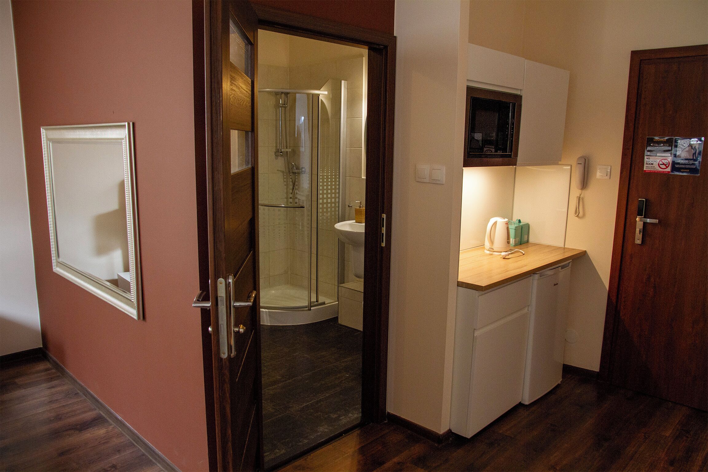 A bathroom with a glass shower enclosure, a sink, and a toilet.