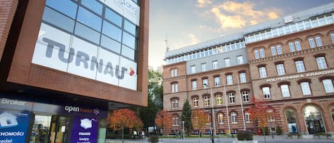 A modern building with a large sign for 'TURNAF' and 'open finance' on the ground floor.