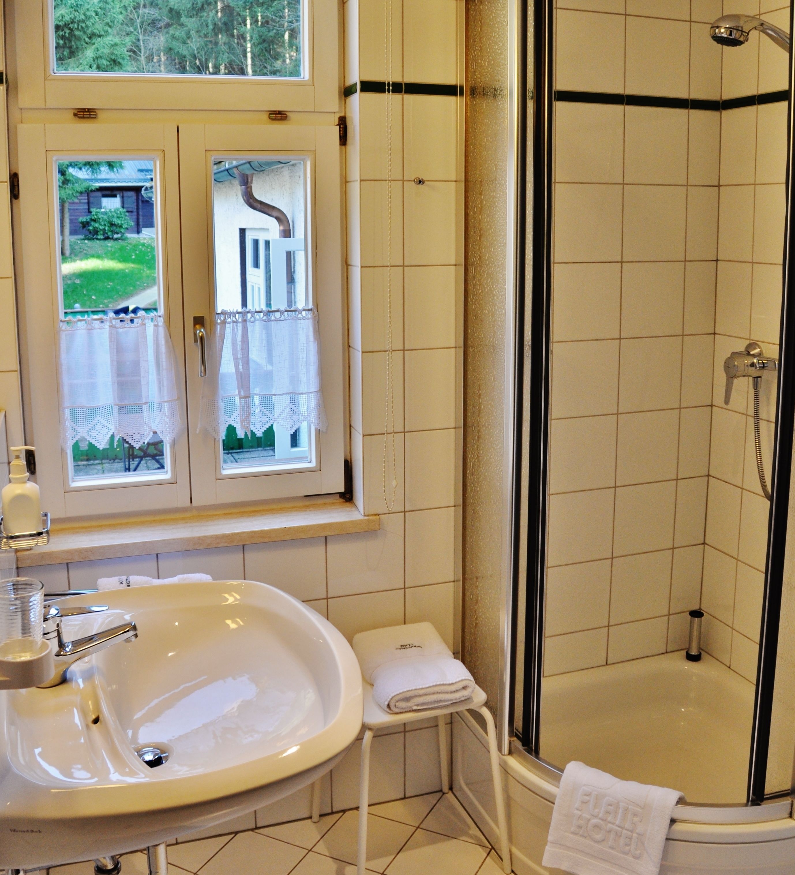 comfort single room (plus) | bathroom | shower, free toiletries, hair dryer, bathrobes