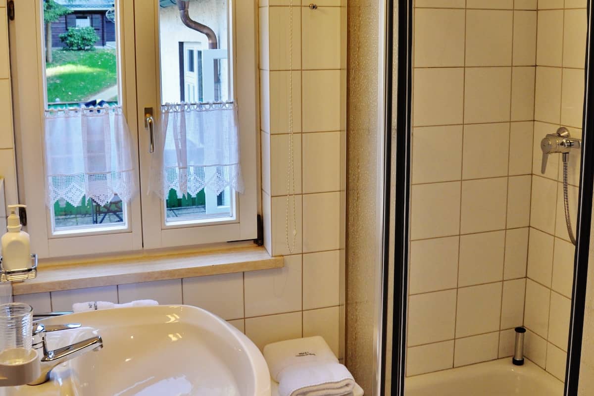 comfort single room (plus) | bathroom | shower, free toiletries, hair dryer, bathrobes